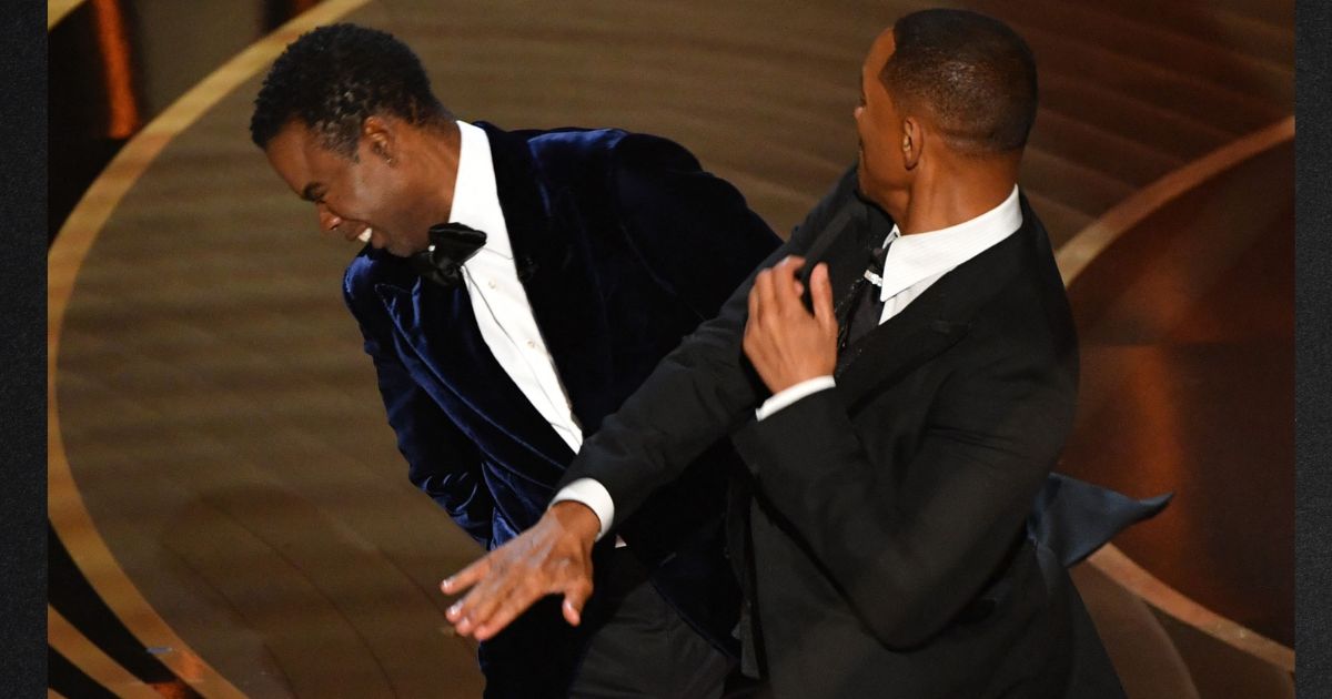 Actor Will Smith, right, slaps actor Chris Rock onstage during the 94th Oscars in Hollywood, California on March 27, 2022.