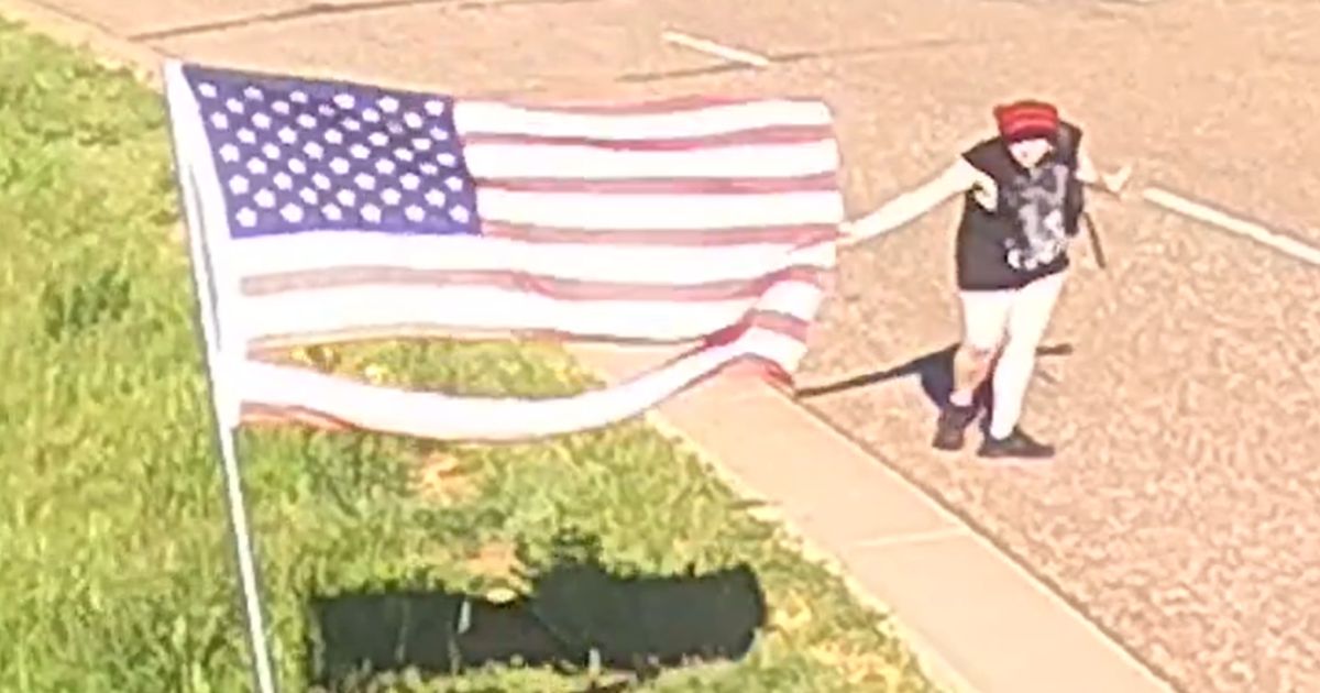Watch: Shocking Video Shows Vandal Tearing Down 7 Flags, Gesturing Rudely at Police
