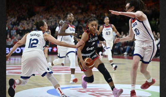 Team USA's Diana Taurasi, left, and Breanna Stewart, right, fight for the ball with Belgium's Maxuella Lisowa Mbaka, center, during the FIBA Women's basketball qualification match for the 2024 Paris Olympics between Belgium and the USA in Antwerp, on Feb.8.