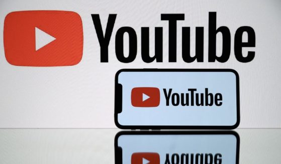 The logo of YouTube is displayed on both a smartphone and a tablet on Oct. 5, 2021.