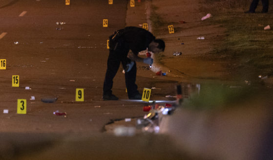 An officer of the Akron Police Department investigating a shooting that happened overnight in Akron, Ohio, on Sunday.