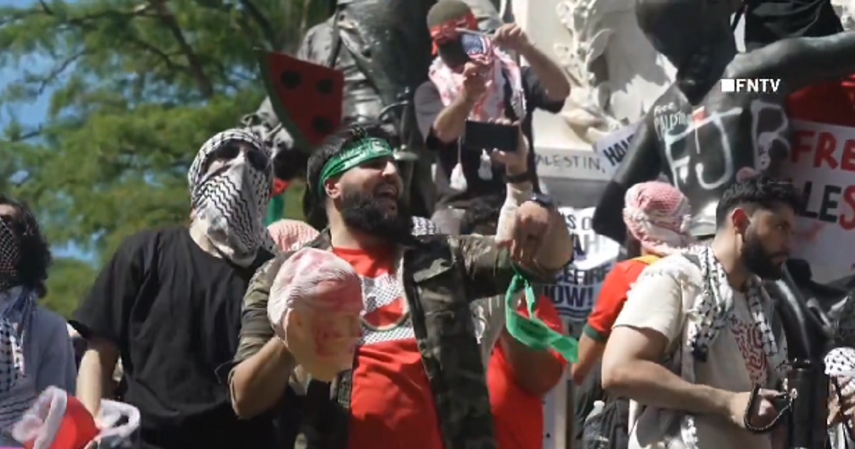 A pro-Palestinian protester holds a mask of Joe Biden that appears bloody during a demonstration Saturday in Washington, D.C.