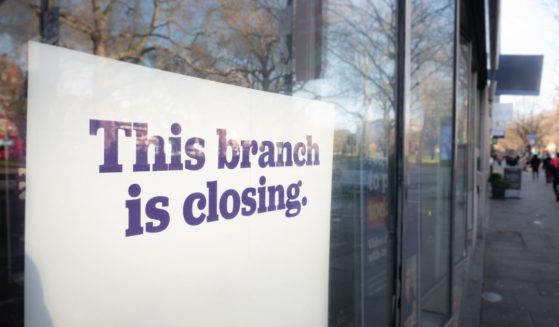 A stock photo shows a sign in a window that reads, "This branch is closing."