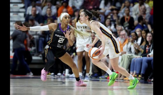 Caitlin Clark #22 of the Indiana Fever dribbles the ball against DiJonai Carrington #21 of the Connecticut Sun during the second quarter in the game at Mohegan Sun Arena on May 14, 2024 in Uncasville, Connecticut.