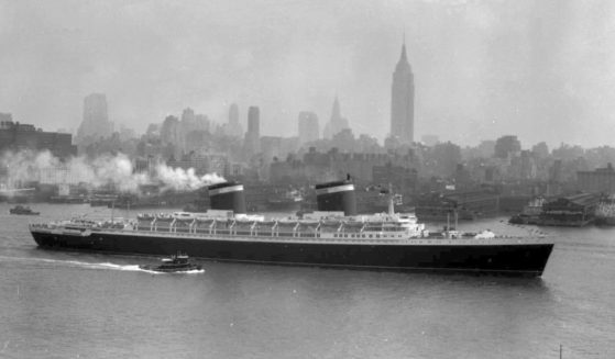 The SS United States glides down the Hudson River as it begins its first voyage to Europe from New York in view of the Manhattan skyline, including the Empire State Building on the center right, in this view from Hoboken, New Jersey on July 3, 1952.