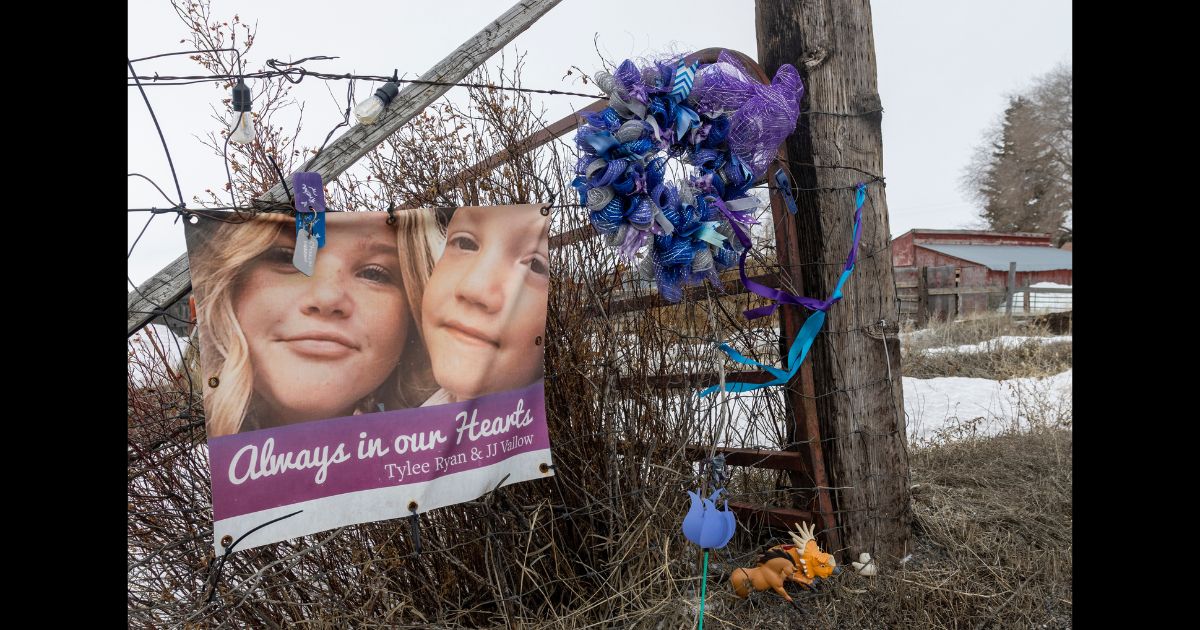 A picture of Tylee Ryan (L) and J.J. Vallow is seen on a fence opposite the property where their bodies were found in 2020, on April 4, 2023 in Rexburg, Idaho.