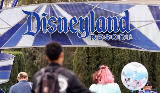 People walk toward an entrance to Disneyland on April 24, 2023 in Anaheim, California.