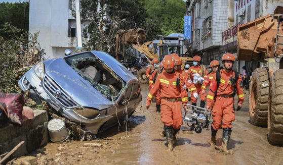In this photo released by Xinhua News Agency, rescuers carrying rescue equipment enter a flood-affected in Wuping County of Longyan City, southeast China's Fujian Province, Thursday, June 20, 2024. A family of six was found dead by rescuers in Fujian province, state media reported Saturday, adding to the extreme weather deaths after downpours caused landslides in the area, even as authorities extended a warning of more severe weather ahead.