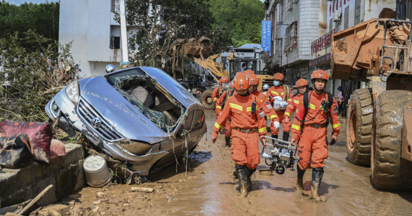 In this photo released by Xinhua News Agency, rescuers carrying rescue equipment enter a flood-affected in Wuping County of Longyan City, southeast China's Fujian Province, Thursday, June 20, 2024. A family of six was found dead by rescuers in Fujian province, state media reported Saturday, adding to the extreme weather deaths after downpours caused landslides in the area, even as authorities extended a warning of more severe weather ahead.