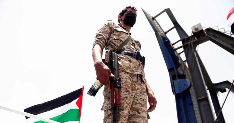 A fighter of the Houthi group stands on the Galaxy Leader Vessel as he guards it, on the Red Sea coast off Hudaydah, on May 12, 2024, in the Red Sea, Yemen.