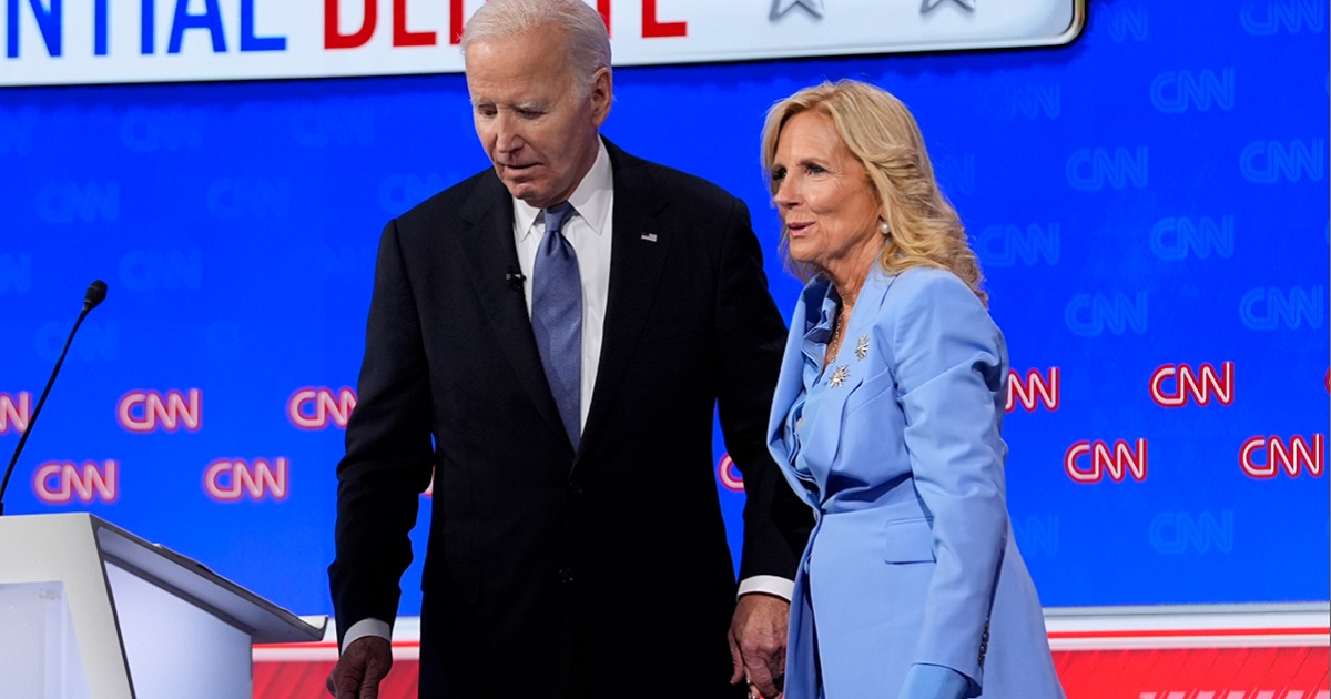 President Joe Biden holds first lady Jill Biden's hand as they prepare to leave the stage after Thursday's presidential debate in Atlanta.