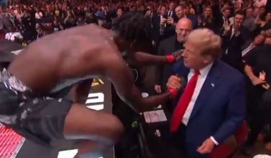 UFC fighter Kevin Holland shakes former President Donald Trump's hand have winning a bout Saturday night.