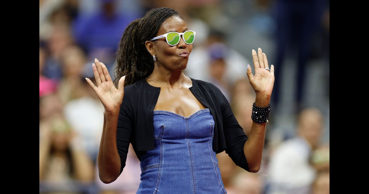 Former first lady of the United States Michelle Obama reacts during a ceremony honoring 50 years of equal pay at the U.S Open during the Women/Men's Singles First Round matches on Day One of the 2023 US Open at the USTA Billie Jean King National Tennis Center on August 28, 2023 in the Flushing neighborhood of the Queens borough of New York City.