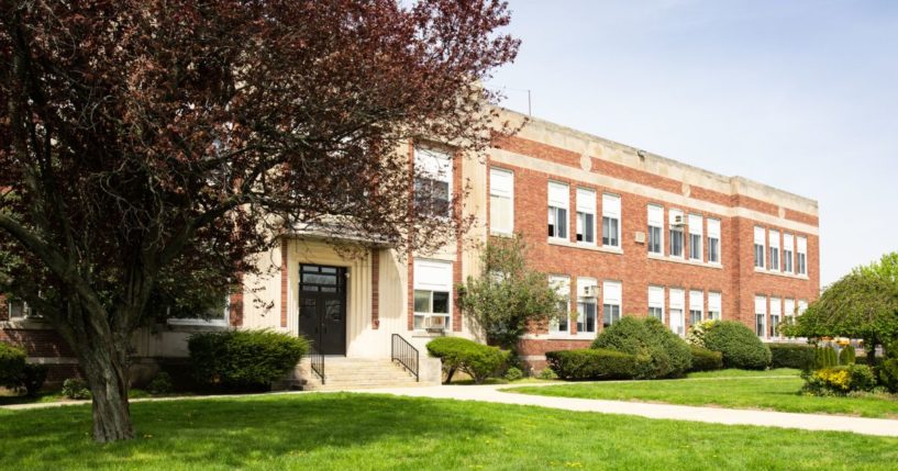 A stock photo shows a typical American school.