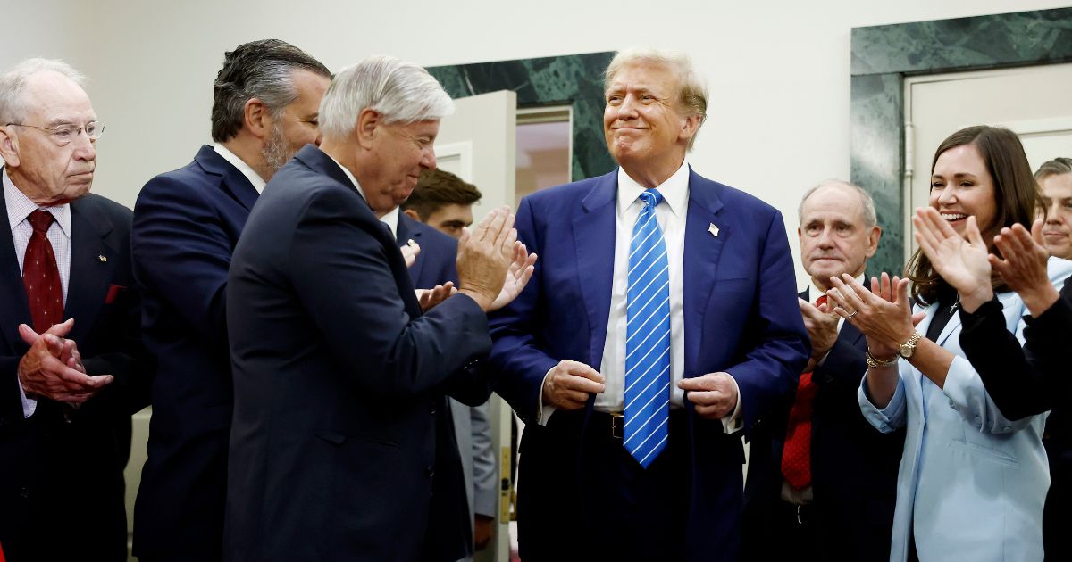 Republican presidential candidate, former U.S. President Donald Trump is applauded by Senate Republicans before giving remarks to the press at the National Republican Senatorial Committee building on June 13, 2024 in Washington, DC.