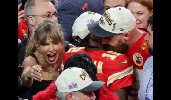 (L-R) Taylor Swift, wide receiver Mecole Hardman Jr. #12 and tight end Travis Kelce #87 of the Kansas City Chiefs celebrate after the Chiefs' 25-22 overtime victory over the San Francisco 49ers in Super Bowl LVIII at Allegiant Stadium on February 11, 2024 in Las Vegas, Nevada.