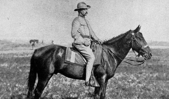 Portrait of Colonel Theodore Roosevelt on a horse, in a field, 1898.