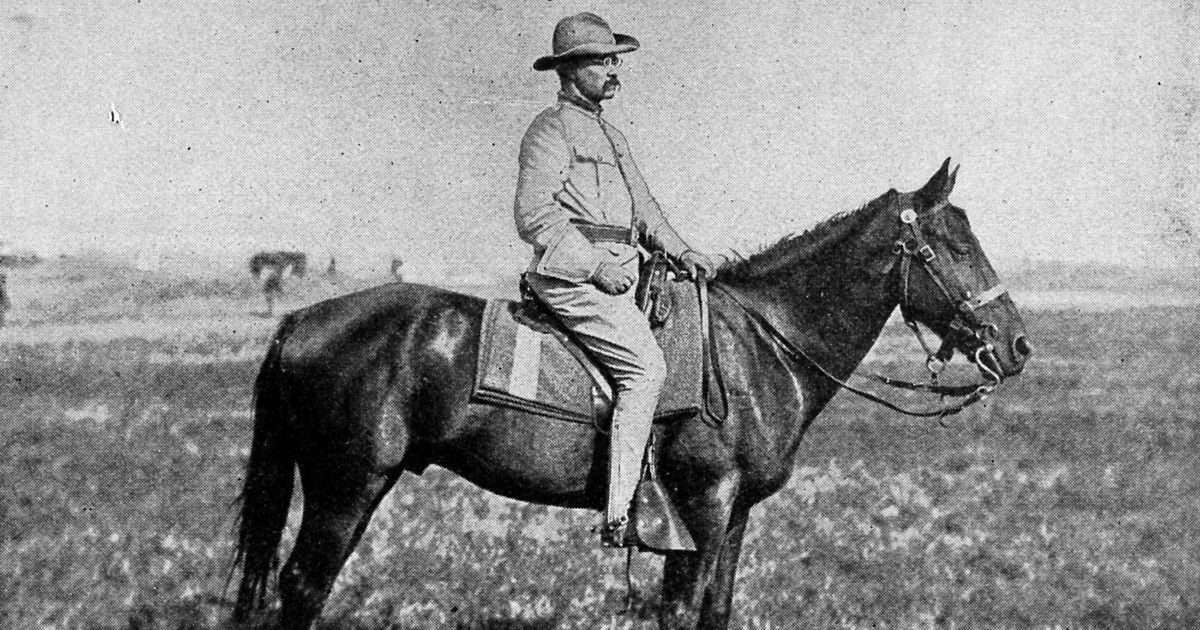 Portrait of Colonel Theodore Roosevelt on a horse, in a field, 1898.