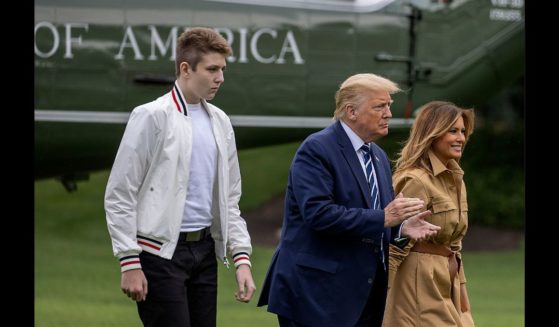Barron Trump, US President Donald Trump and First lady Melania Trump walk on the South Lawn of the White House on August 16, 2020 in Washington, DC.