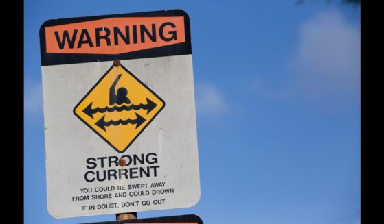 Sign posted on beach warning against strong current on November 12, 2015 in Haleiwa, Hawaii.