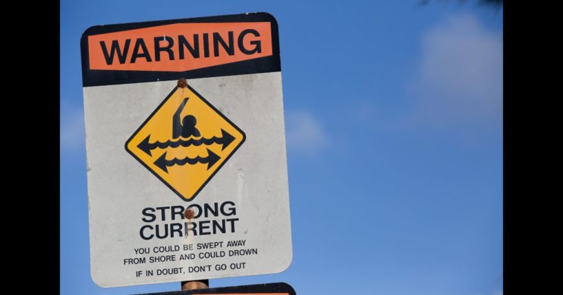 Sign posted on beach warning against strong current on November 12, 2015 in Haleiwa, Hawaii.