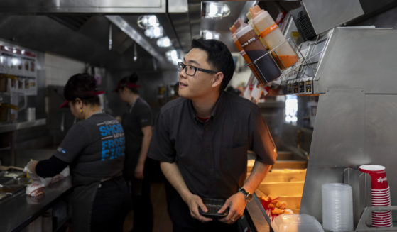 Lawrence Cheng, whose family owns seven Wendy's locations south of Los Angeles, works in the kitchen at his Wendy's restaurant in Fountain Valley, California, on June 20.