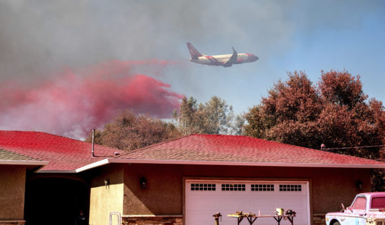 An air tanker drops fire retardant while trying to keep the Grubbs Fire from spreading in the Palermo community of Butte County, California, on Wednesday.