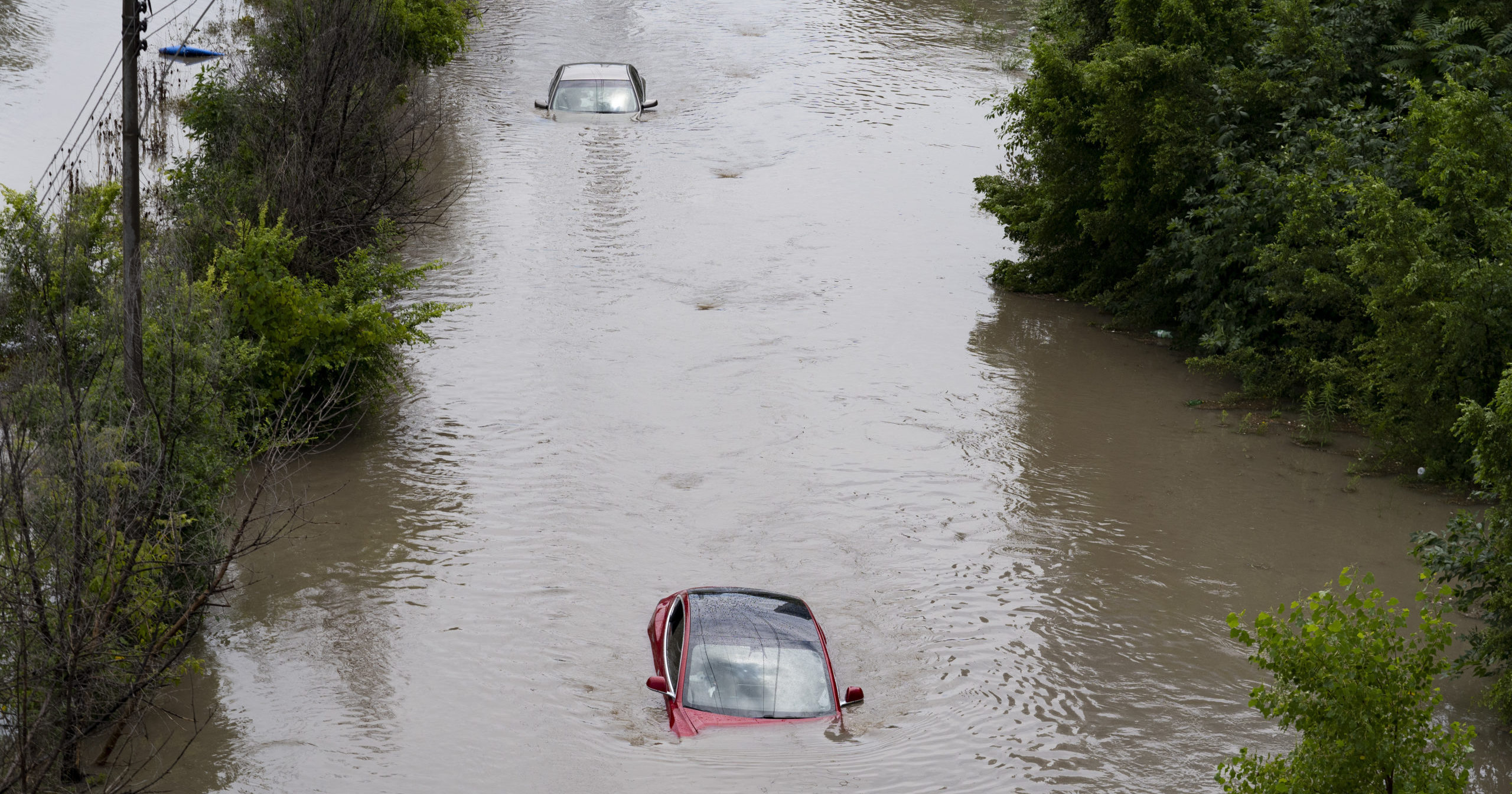 Cars are partially submerged in floodwaters in the Don Valley following heavy rain in Toronto on Tuesday.