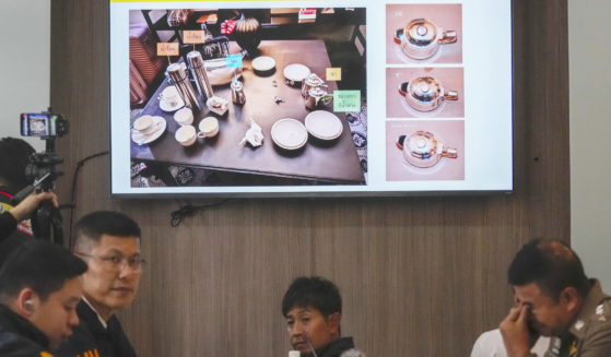 Thai police display photos of evidence during a news conference at the Lumpini police station in Bangkok on Wednesday.