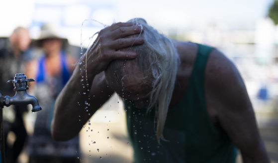 A person cools off during the Waterfront Blues Festival on Friday in Portland, Oregon.