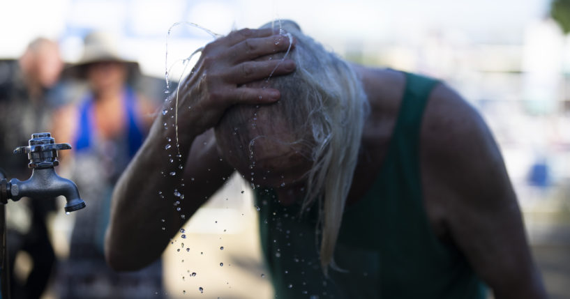 A person cools off during the Waterfront Blues Festival on Friday in Portland, Oregon.