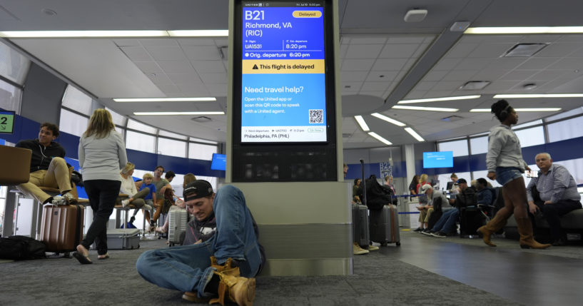 Travelers delayed by Friday's internet outage wait it out in Chicago's O'Hare International Aiport. (Travelers delayed by Friday's internet outage wait it out in Chicago's O'Hare International Aiport.