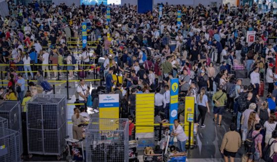 Long lines of passengers form at the check-in counters at Ninoy Aquino International Airport in Manila amid a global IT disruption on Friday.