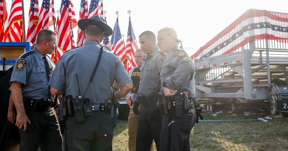 Law enforcement agents stand near the stage of a campaign rally in Butler, Pennsylvania, where Republican presidential candidate and former President Donald Trump was targeted in an assassination attempt on Saturday.