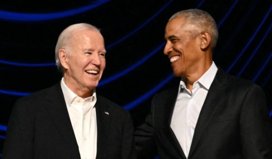 President Joe Biden stands on stage with former President Barack Obama during a campaign fundraiser at the Peacock Theater in Los Angeles on June 15.