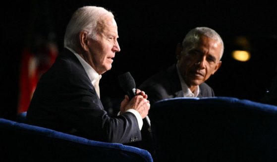 President Joe Biden, left, speaks next to former President Barack Obama, right, onstage during a campaign fundraiser at the Peacock Theater in Los Angeles, California, on June 15.