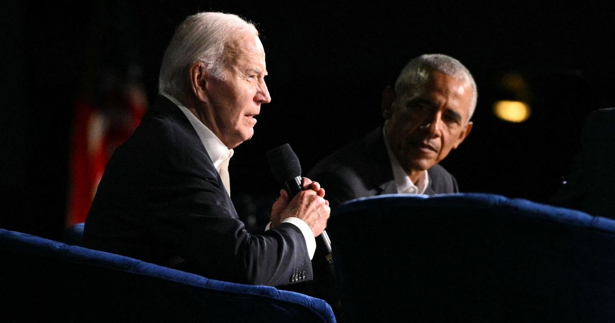 President Joe Biden, left, speaks next to former President Barack Obama, right, onstage during a campaign fundraiser at the Peacock Theater in Los Angeles, California, on June 15.