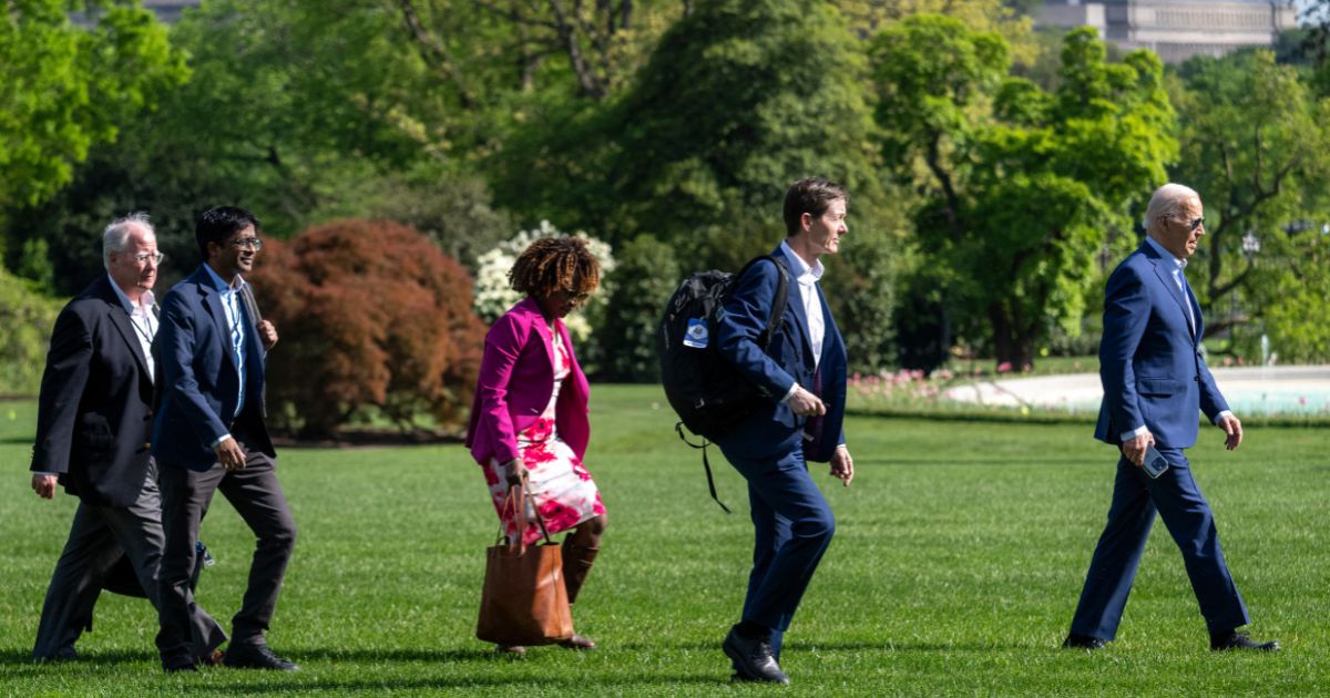 President Joe Biden, right, walks with members of his staff across the South Lawn of the White House in Washington, D.C., in April 18.