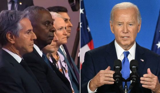 Members of his administration, left, watch as President Joe Biden, right, speaks during a news conference at the Walter E. Washington Convention Center in Washington on Thursday.