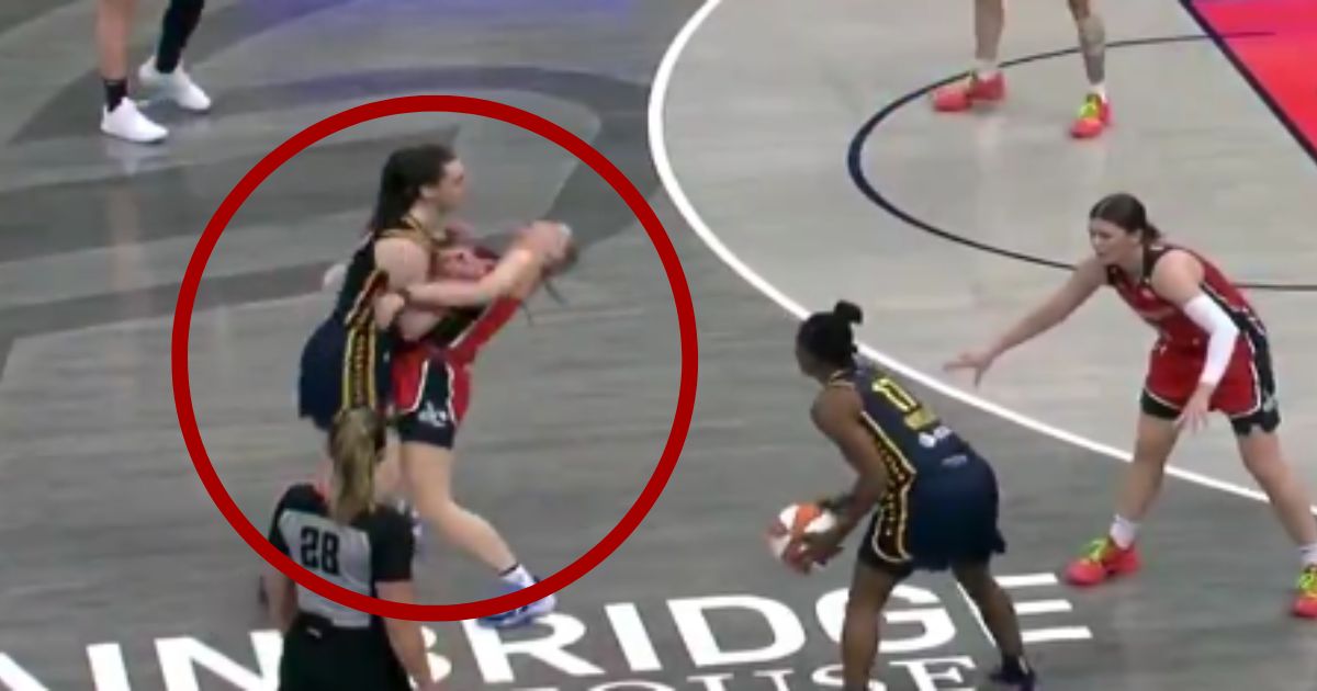 Indiana Fever rookie Caitlin Clark, left, shoved Washington Mystics player Julie Vanloo, center, during Wednesday's game.