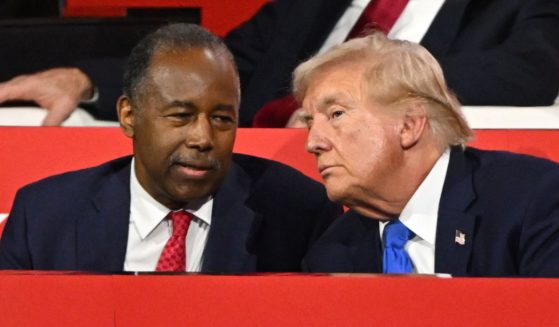 Former Housing and Urban Development Secretary Dr. Ben Carson speaks with Republican presidential candidate and former President Donald Trump on the second day of the Republican National Convention at the Fiserv Forum in Milwaukee on Tuesday.