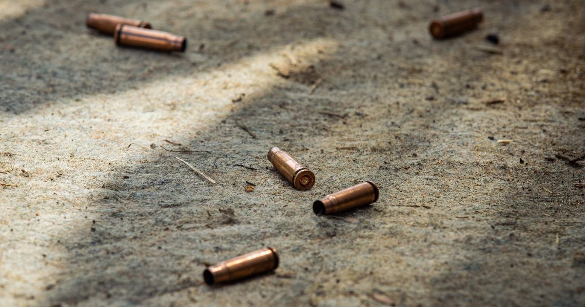 A stock photo shows cartridge cases from bullets shot by an AK-74 rifle lying on the ground.