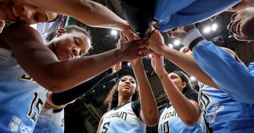 Angel Reese, center, stands with teammates of the Chicago Sky after beating the Seattle Storm in Seattle, Washington, on Friday.