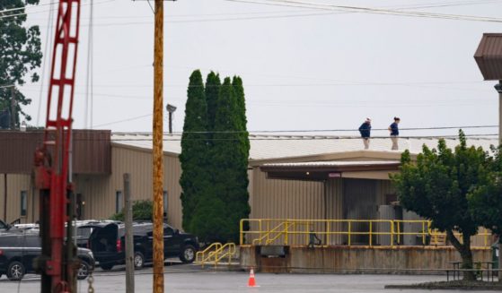 On July 14, two FBI investigators scan the roof of AGR International Inc, the building adjacent to the Butler Fairgrounds, from which shooter Matthew Thomas Crooks fired at former President Donald J. Trump.