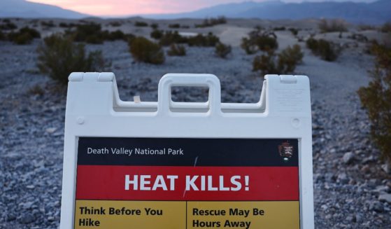 A sign reading "Heat Kills!" is seen Monday during a long-duration heat wave at Death Valley National Park, California.