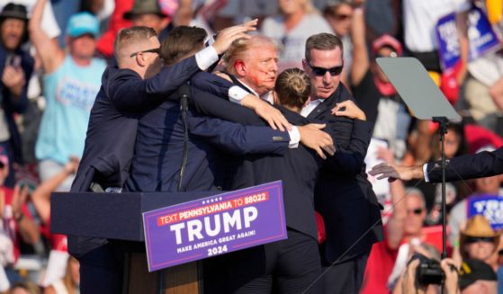 Former President Donald Trump walks off stage after an assassination attempt at a campaign rally in Butler, Pennsylvania, on Saturday.