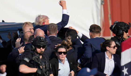 Former President Donald Trump is escorted to a motorcade following an attempted assassination at a campaign event in Butler, Pennsylvania, on Saturday.