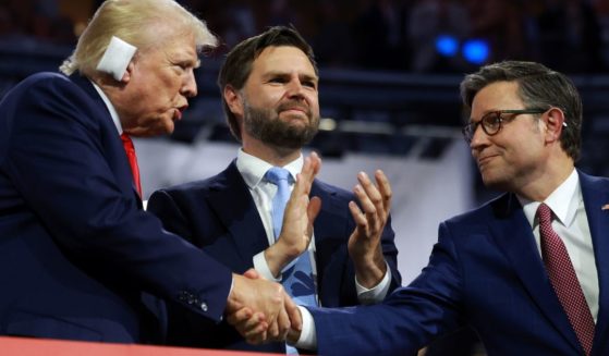 Republican presidential candidate, former U.S. President Donald Trump (L), Republican vice presidential candidate, U.S. Sen. J.D. Vance (C), and Speaker of the House Mike Johnson (R) attend the first day of the Republican National Convention at the Fiserv Forum on July 15 in Milwaukee, Wisconsin.