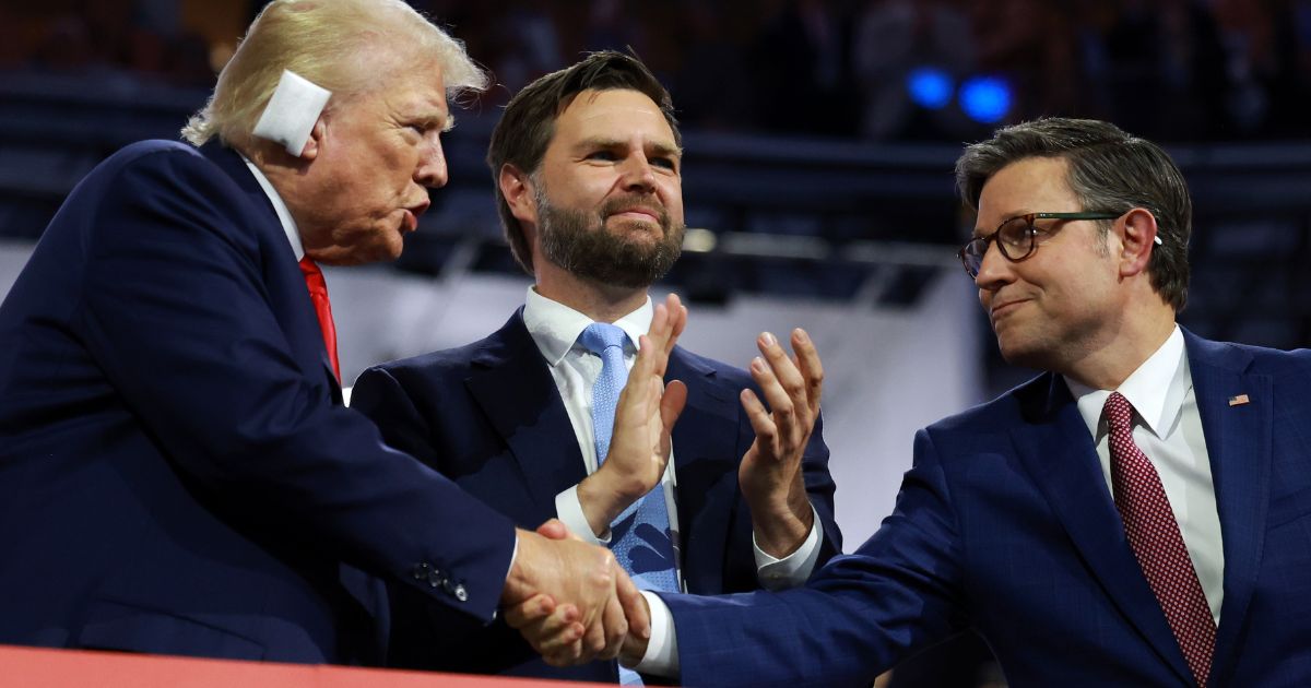 Republican presidential candidate, former U.S. President Donald Trump (L), Republican vice presidential candidate, U.S. Sen. J.D. Vance (C), and Speaker of the House Mike Johnson (R) attend the first day of the Republican National Convention at the Fiserv Forum on July 15 in Milwaukee, Wisconsin.