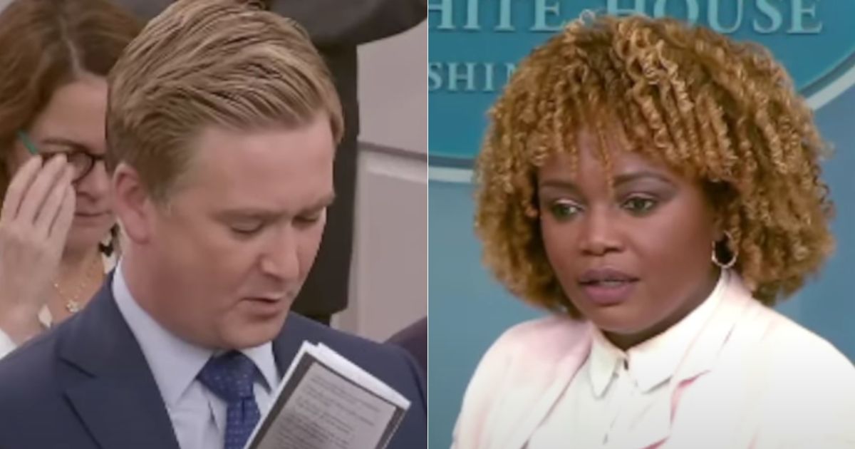 Fox News White House correspondent Peter Doocy, left, holds up a card with talking points on Vice President Kamala Harris' role at the border while asking White House press secretary Karine Jean-Pierre, right, a question about Harris' role as "border czar."